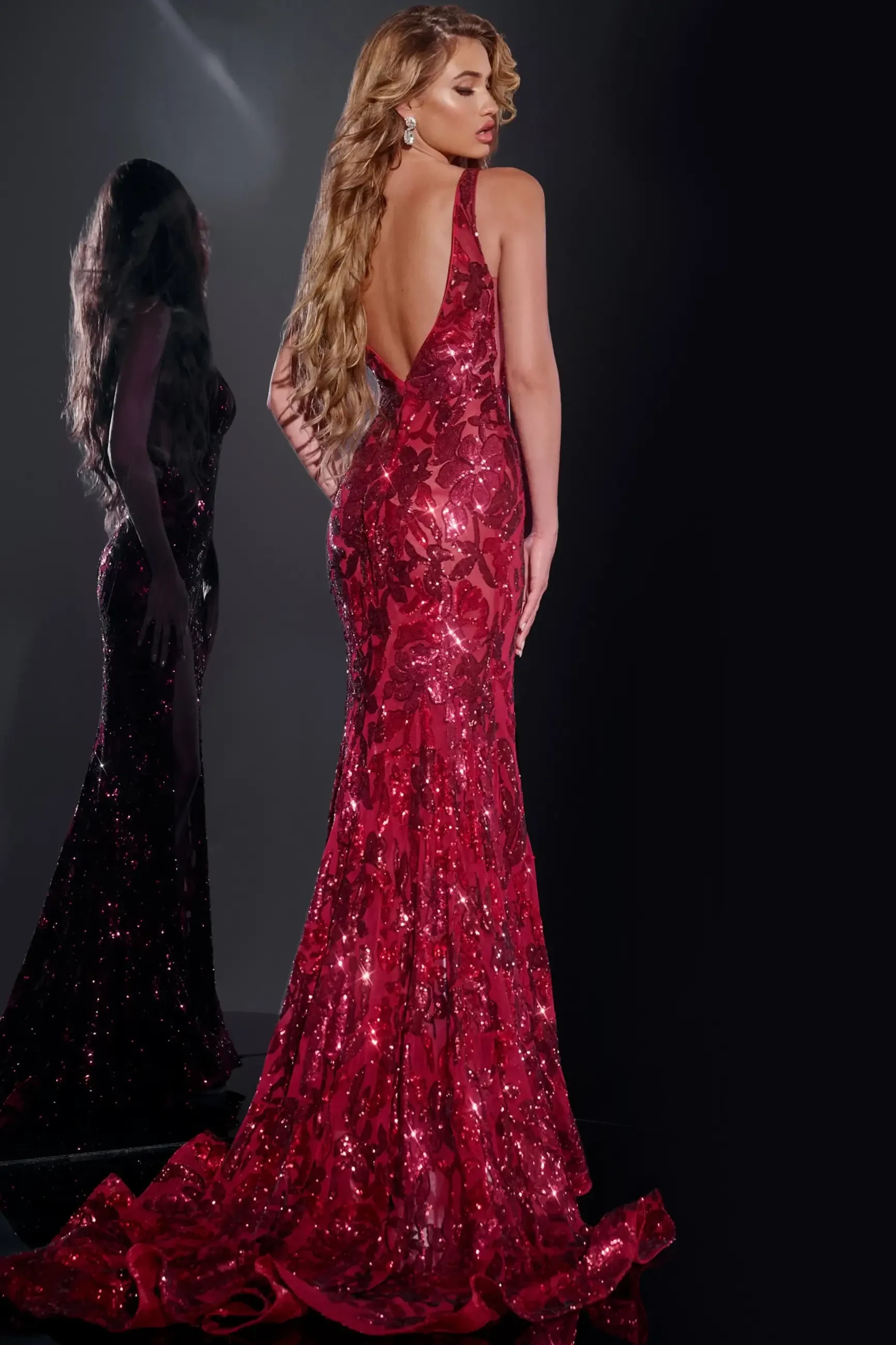 model is wearing a sequin sleeveless fit and flare prom dress